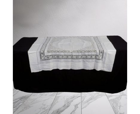 Lot includes white cotton tablecloth (52"L x 52"W) with crocheted center and border design and 13 square linen coasters with 