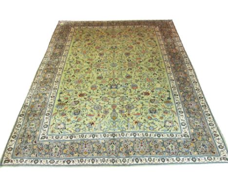 VERY FINE KASHAN CARPET, 378cm x 292cm, of overall scrolling vines and palmettes on a jade field within ivory bands and azure