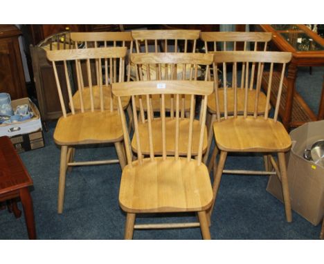 A SET OF SEVEN MODERN LIGHT OAK DINING CHAIRS