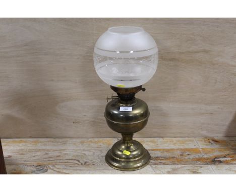 A BRASS OIL LAMP WITH BRASS ETCHED SHADE 