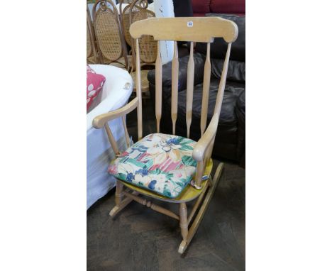 A light beech rocking elbow chair with slat back