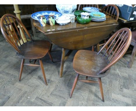 4' Ercol oak drop leaf dining table and four similar stick back Windsor style chairs 