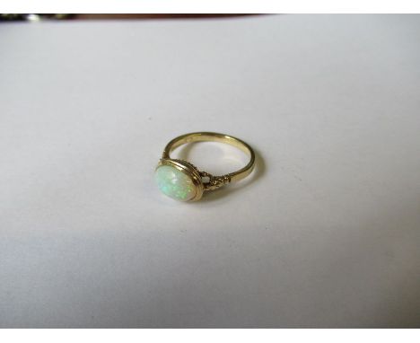 A 9ct gold ring, set with an opal, with carved shoulders, weight 3g - Ring size N 1/2, There are no breaks or damage to the r