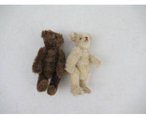 A Steiff miniature brown bear, height 3.75ins, together with another similar bear in pale plush, possibly Steiff as well