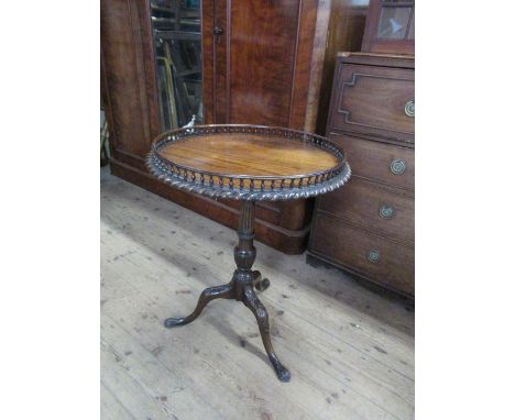 A circular mahogany occasional tripod table, with a gallery and gadroon border&nbsp;