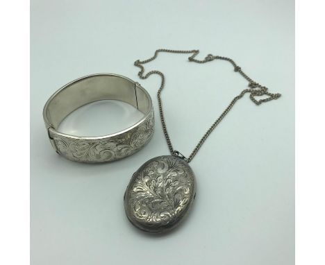 A Lot of two Birmingham silver jewellery items. Ornate bangle and Ornate locket, Locket comes with silver chain. 