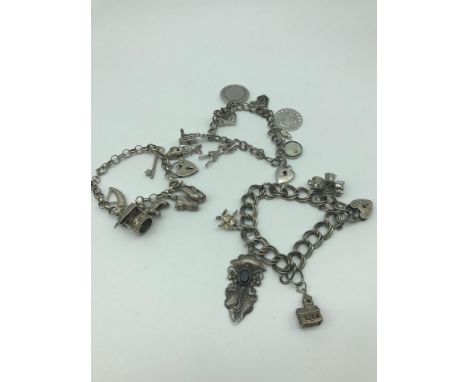 A Lot of three silver charm bracelets with Charms. 21 charms in total. 