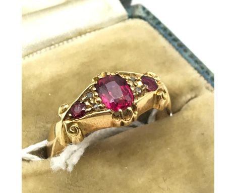 Antique Chester 18ct gold ladies ring, set with three pink stones and four diamond chips [ring size N] [Weighs 2.7grams]. Fit