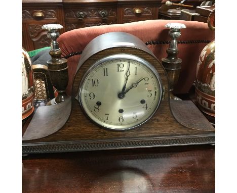 West Minster chime mantel clock with a pair of dark oak candle sticks. Clock comes with key and pendulum. 
