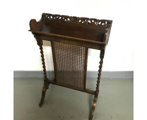 Antique dark oak and bergere firescreen designed with a small bookshelf to the top. Measures 76 height 52 width 35cm base dep