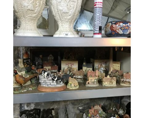 A Shelf of collectable Border fine arts animal figures together with a selection of David Winter Cottage sculptures. 
