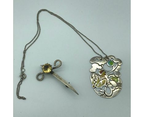 Two Edinburgh silver jewellery items which consists of silver and enamel Hen pendant with silver chain and a silver kilt pin 