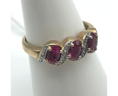 A Lovely example of a ladies 9ct gold ring set with three large pink cut stones and finished with 4 round cut diamonds. 0.01c