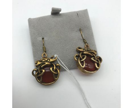 A Pair of hand made Celtic dragon design gold tone earrings set with a red agate stone. Marked SG total weight 9.8grams 