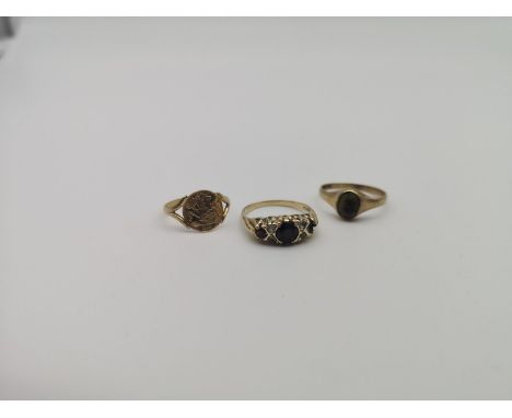 A Lot of three 9ct gold rings, Which includes George and dragon coin style ring, ladies garnet and clear stone ring (one ston