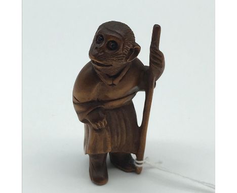 A Highly carved Japanese netsuke figure of a Monkey King with black bead eyes. Signed to the base and Measures 5.7cm in heigh