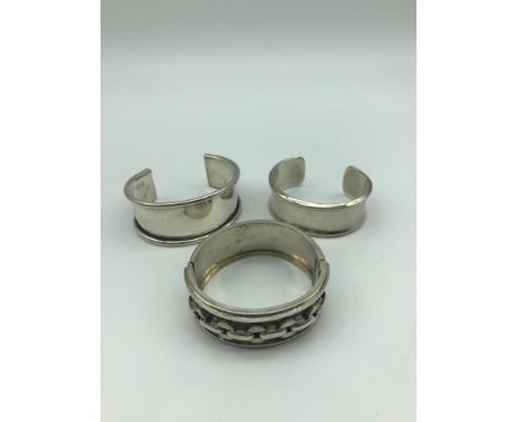 A Lot of three heavy silver bangles. 