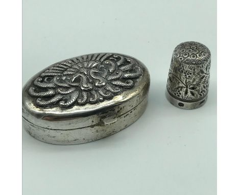 An 800 Grade silver Persian pill box, lid is detailed with two peacocks with feathers spread, together with a Birmingham silv