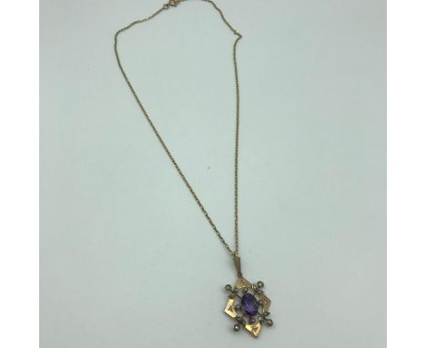 An Art Nouveau 9ct gold pendant with a 9ct gold chain, Pendant is made up of seed pearls and amethyst stones 
