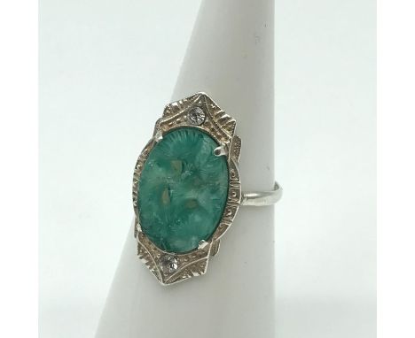 A Possible Chinese silver export (unmarked) ring set with a hand carved jade stone. 