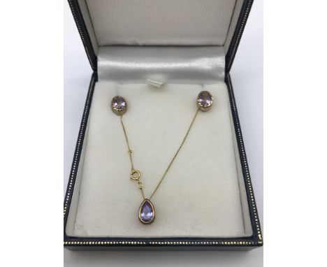 A 9ct gold chain, 9ct gold and Amethyst pendant and matching earrings. 