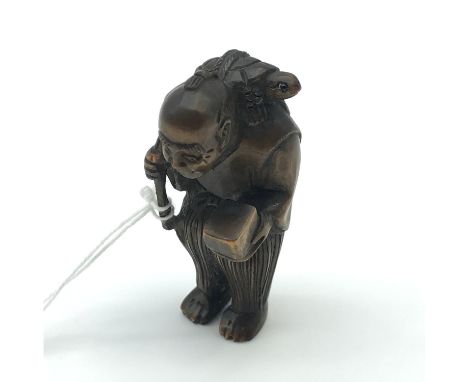 A Highly carved Japanese netsuke figure of an elderly gentleman carrying a box and a turtle on his shoulder. Turtle has black