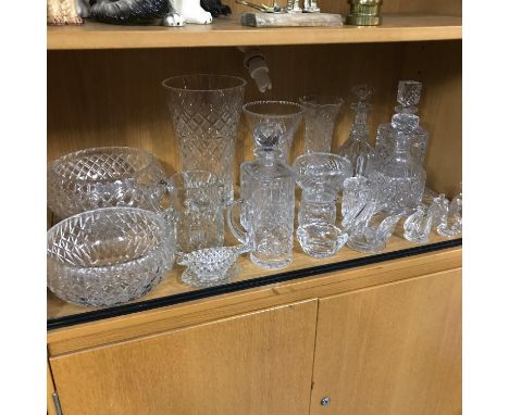 A shelf filled with quality cut crystal vases, bowls and decanters to include large Edinburgh crystal vase (height 30cm) 