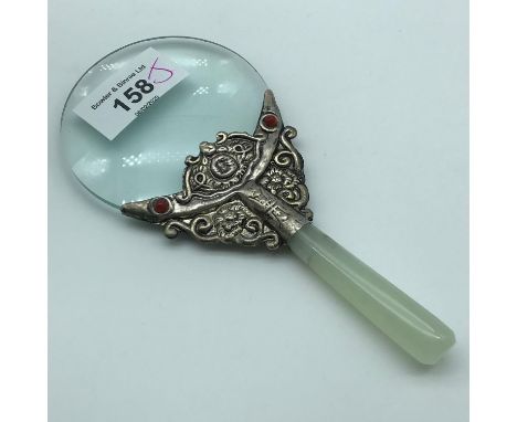 A Vintage Chinese hand mirror with jade handle. Measures 15.5cm in length 