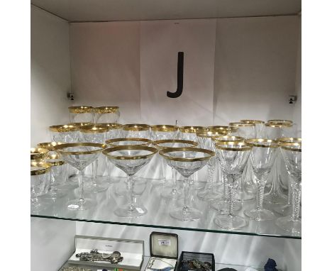 A Shelf of Stylish Victorian/Edwardian crystal wine, sherry, cocktail and whisky glasses. All designed with a gilt painted ri