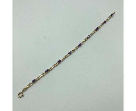 A lovely example of a 9ct gold and Amethyst stone (9) bracelet. Weighs 4.4grams 