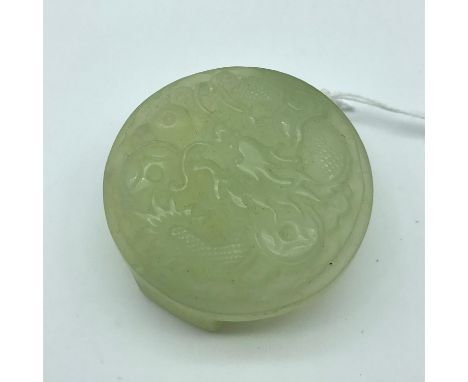 A Chinese jade hand carved dragon design belt buckle. Measures 5.5cm in diameter 
