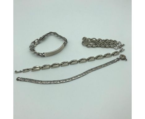 A Lot of 4 silver bracelets which includes London silver curb I.D Bracelet and silver charm bracelet 