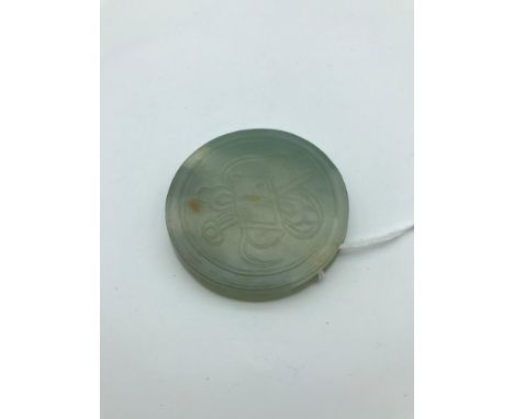 A Chinese Qing jade carved belt buckle, Measures 5.2cm in diameter 