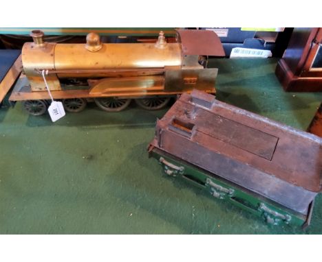 A 2.5" gauge hand built model steam locomotive and six wheel tender, the unpainted brass engine on a green painted chassis, b