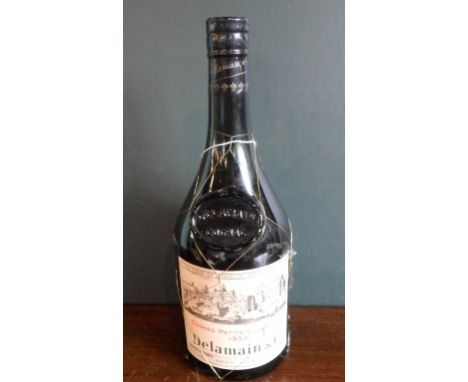 A bottle of Delamain & Co., Cognac Petite Champagne, 1920, (70% proof). Condition Report: Condition is generally good, with t