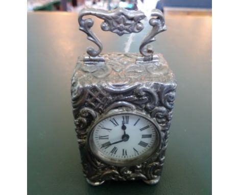 A silver cased miniature mantle clock, Birmingham hallmarks 1901, (9cm handle up).