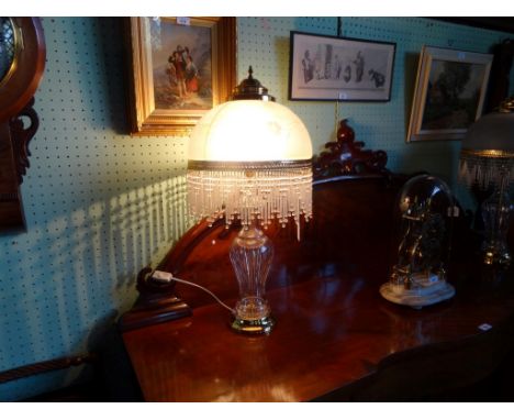 A large contemporary crystal glass baluster and gilt mounted table lamp, the frosted glass dome having graduated glass drops,