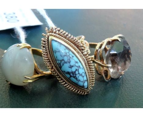 A circular citrine dress ring, together with a banded agate dress ring and a large single stone turquoise dress ring.