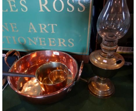 A brass pedestal oil lamp, together with a large twin handled copper pan, a brass pan and a small white metal bowl.