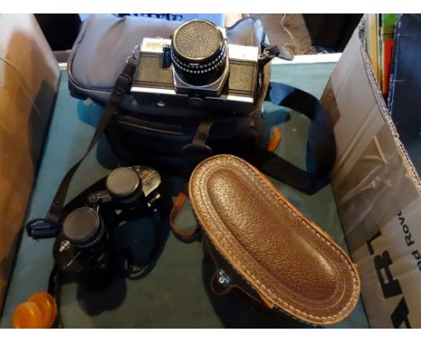A Praktica MTL5 camera, together with a Sigma lens and other accessories and a cased pair of Swiss Apollo 8 x 30 binoculars, 