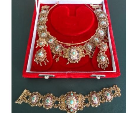 An Indian enamel, seed pearl and turquoise fringe necklace, bracelet and earrings suite, the necklace with oval panels decora