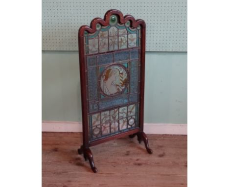 An Arts & Crafts period mahogany framed stained glass panel, possibly by Morris & Co., having central circular pre-Raphaeliit