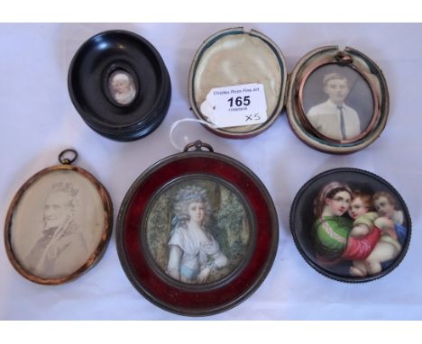 A 19th century circular portrait miniature of a lady in 18th century dress, within a red enamel border, together with two oth