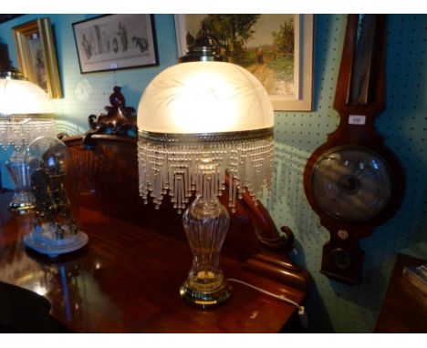 A large contemporary crystal glass baluster and gilt mounted table lamp, the frosted glass dome having graduated glass drops,