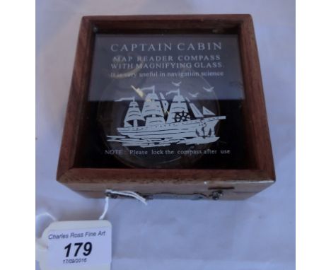 A reproduction cased Captain Cabin map reader compass with magnifying glass.