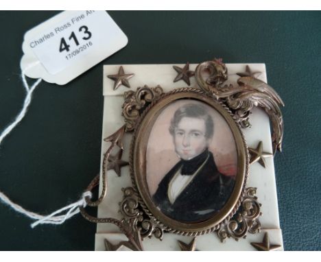 A 19th century portrait miniature, possibly American, of a gentleman, oval in an ornate brass bound bone frame.