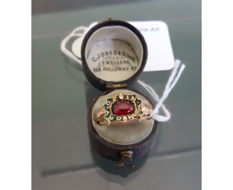 A mid-19th century mourning ring with central cabochon garnet, within engraved black enamel band, commemorative engraving to 