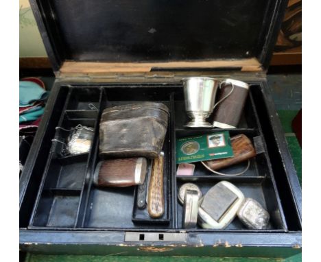 A large 19th century leather box containing assorted items, to include: three white metal decanter labels, a silver christeni