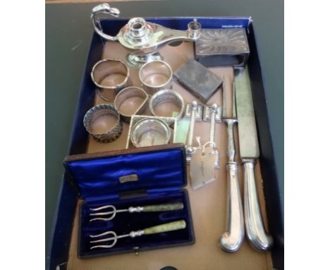 A mixed quantity of silver and white metal, to include: a pair of knife rests, napkin rings, a carving knife and fork, a boxe