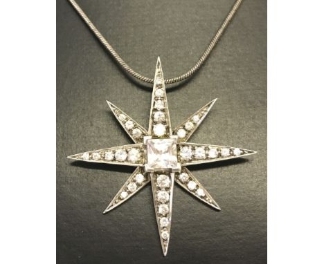 A pretty silver star shaped pendant set with clear stones on a 18 inch silver snake chain.  
